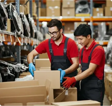Warehouse staff preparing and packing tested automotive electronic parts for shipment